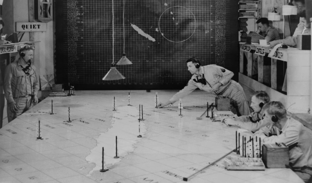 U.S. Army Signal Corps using radar plotting board. They track aircraft at 1st Island Command Headquarters, Noumea, New Caledonia. 1943.