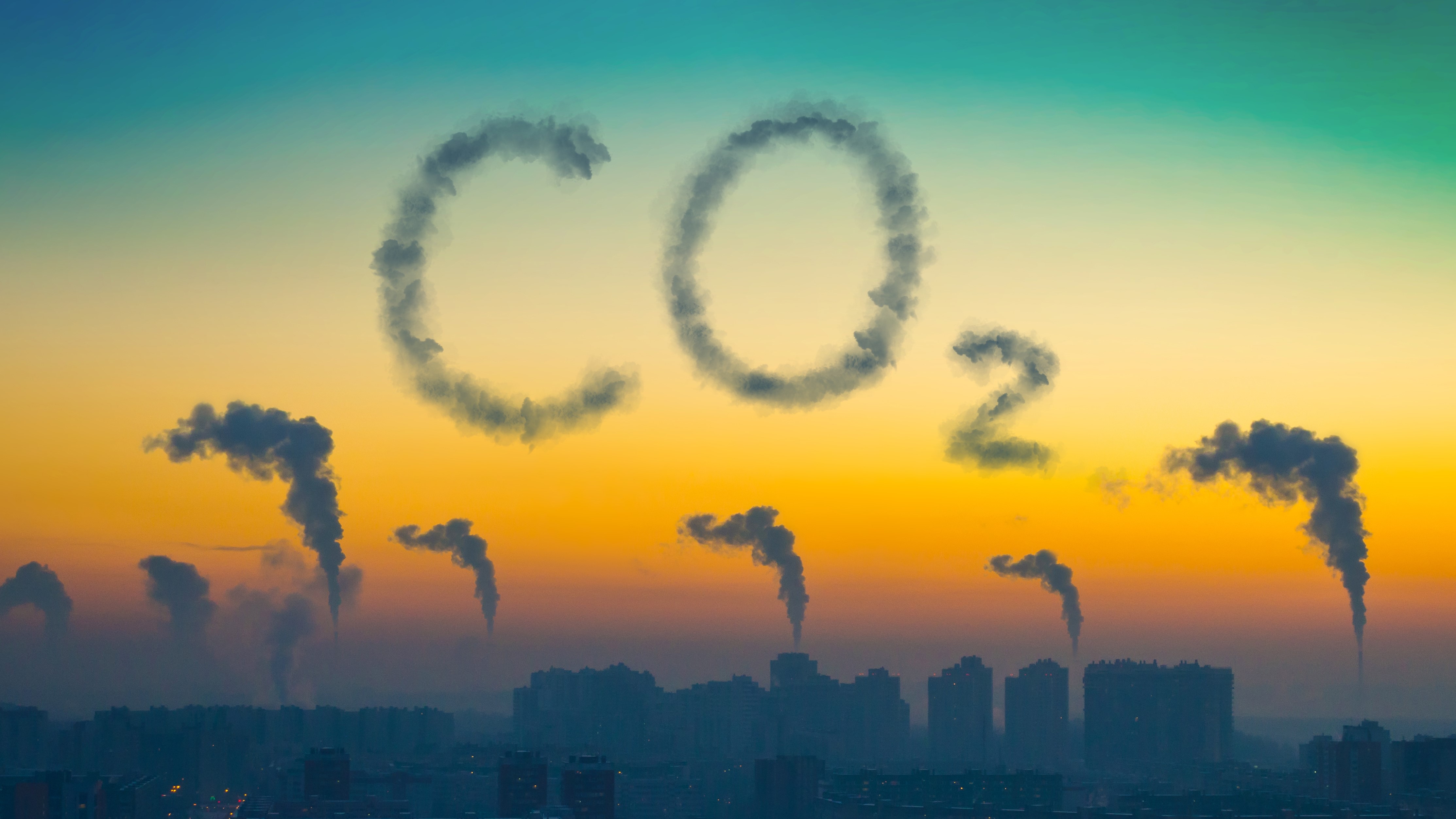 Evening view of the industrial landscape of the city with smoke emissions from chimneys